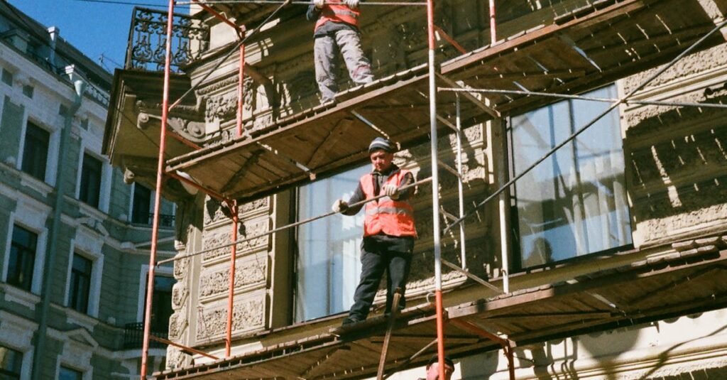 pexels-photo-2209529-2209529 Men on Brown Scaffolding